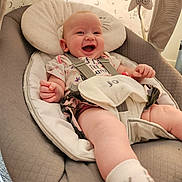 Miah joined the competition — help win amazing prizes! baby, smiling, infant, baby_seat, cushion, harness, sock, clothing, indoor, happy, cute, child, person, fabric, toy, pattern, head_support, star, moon, baby_toys