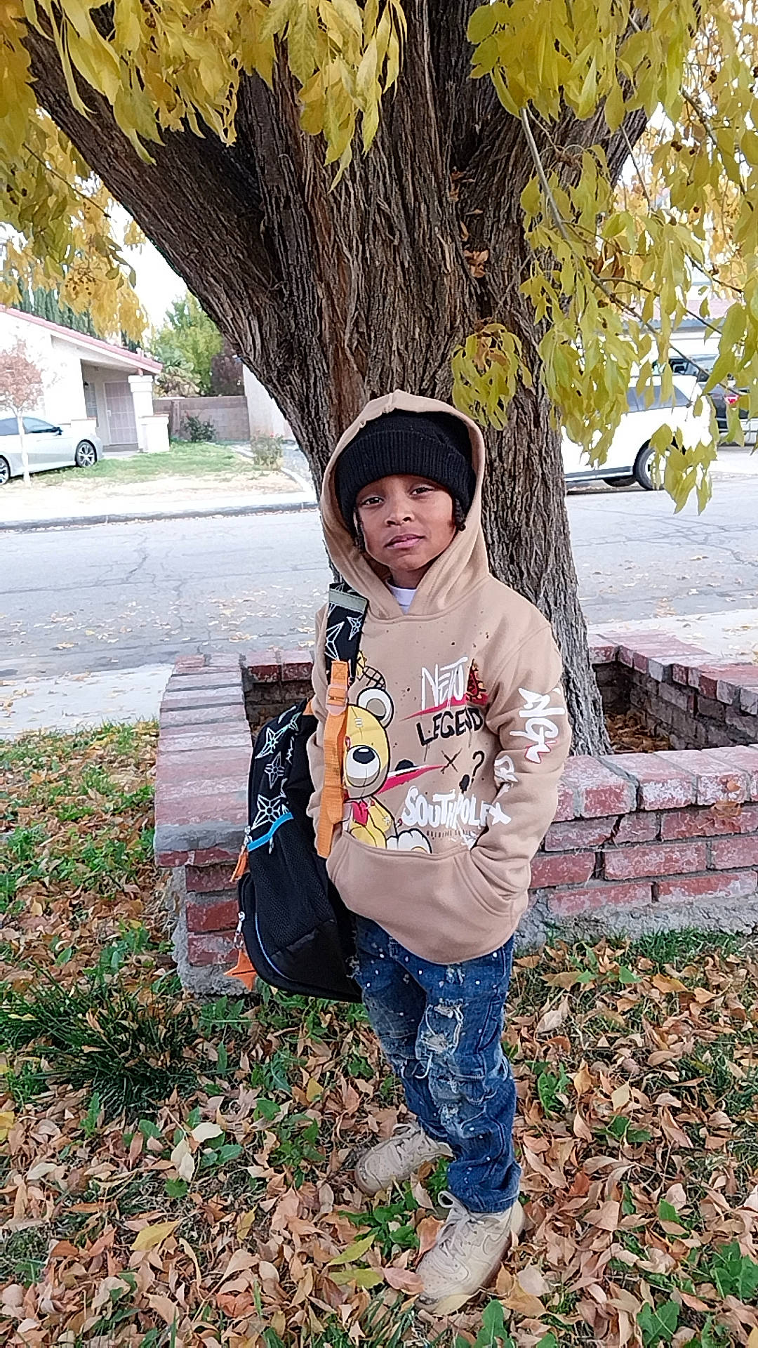 Jonathan is registered to the contest to win money with this photo: cap, child, denim, fashion_accessory, fun, grass, happy, headwear, leaf, leisure, pattern, people_in_nature, person, plant, recreation, sleeve, tints_and_shades, toddler, tree, wheel