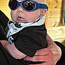 Xander joined the competition — help win amazing prizes! baby, child, infant, sunglasses, portrait, indoor, wooden_wall, adult, holding, arms, scarf, black_clothing, face, head, eyes, fashion, cozy, close_up, photography, family
