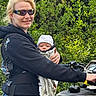 Xander joined the competition — help win amazing prizes! baby, infant, woman, adult, smiling, sunglasses, hat, carrier, blanket, outdoor, forest, greenery, nature, all_terrain_vehicle, atv, vehicle, adventure, family, portrait, photography