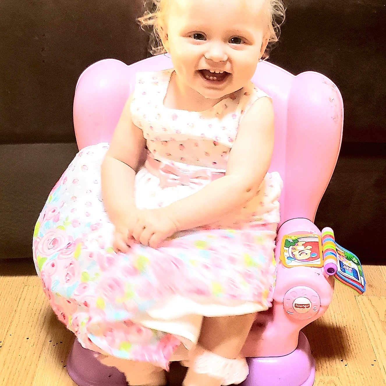 Honest is registered to the contest to win money with this photo: bathroom, child, clothing, dress, face, female, footwear, furniture, girl, happy, head, indoors, person, photography, portrait, potty, room, shoe, sitting, toilet