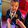 toddler, child, smiling, happy, holding_hands, navy_sweatshirt, lanyard, indoor, red_floor, red_bench, window, person, footwear, cute, baby, playful, portrait, candid, human, expression