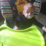 Zaïm participe au concours pour gagner de l'argent avec cette photo : baby, pacifier, high_chair, winnie_the_pooh, child, indoor, colorful, striped_pattern, tray, seat_belt, floor_tiles, curtains, light_and_shadow, person, infant, cute, furniture, toy_design, smile, face