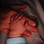 Imrán participe au concours pour gagner de l'argent avec cette photo : baby_hand, adult_hand, clutching, close_up, soft_lighting, fabric, dots_pattern, skin, fingers, tenderness, care, warmth, infant, parent, touch, cuddle, sleepwear, cozy, intimacy, bond