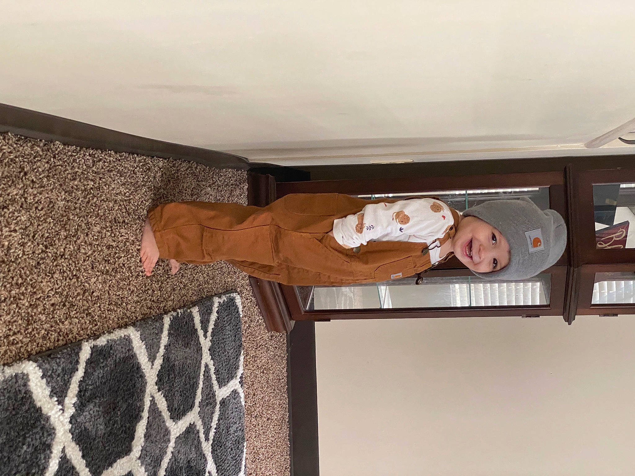 Credence is registered to the contest to win money with this photo: brown, ceiling, child, comfort, elbow, flooring, hardwood, headwear, joy, pattern, person, room, toddler, wood, wrist