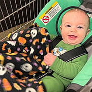 Zane joined the competition — help win amazing prizes! baby, shopping_cart, blanket, child, smiling, green_clothing, halloween, pumpkin, ghost, seatbelt, shopping, infant, happy, indoor, portrait, cute, toddler, face, person, retail