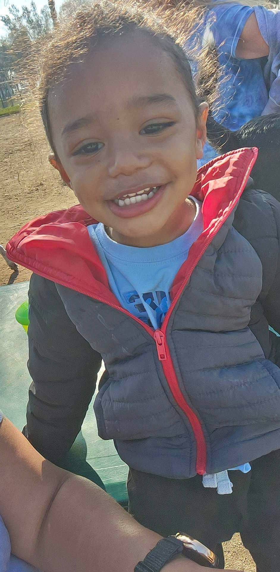 Josiah is registered to the contest to win money with this photo: child, chin, cool, electric_blue, facial_expression, forehead, fun, grass, happy, head, joy, laugh, leisure, nose, person, personal_protective_equipment, recreation, sitting, skin, smile