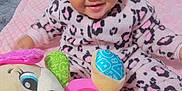 Janiyah joined the competition — help win amazing prizes! baby, child, pink, headband, bow, onesie, leopard_print, plush_toy, musical_toy, smiling, face, indoor, blanket, soft, happy, cute, infant, toy, colorful, sitting