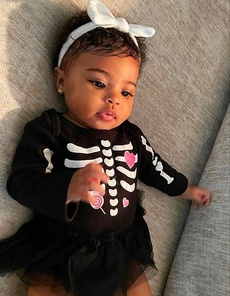 Jay'Lee is registered to the contest to win money with this photo: baby, infant, girl, headband, bow, earrings, black_clothing, skeleton_outfit, pink_hearts, lollipop, couch, gray_couch, tutu_skirt, cute, portrait, indoors, child, smiling, curious, closeup