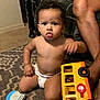 Orlando is registered to the contest to win money with this photo: bare_chest, carpet, child, curious, diaper, expression, floor, furniture, hand, home, indoor, legs, patterned_rug, person, plaid_blanket, play, sitting, toddler, toy_bus, young_child