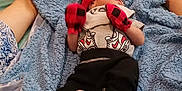 Orlando joined the competition — help win amazing prizes! baby, bed, blanket, blue_blanket, clothing, comfort, cozy, feet, hands, headband, human, indoor, infant, mittens, newborn, person, red, resting, sleeping, soft_texture