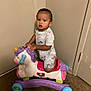 Orlando joined the competition — help win amazing prizes! toddler, child, toy, unicorn, rocker, indoor, carpet, pajamas, dinosaur_print, plastic, wheels, corner, door, wall, person, young_child, playtime, cute, expression, furniture