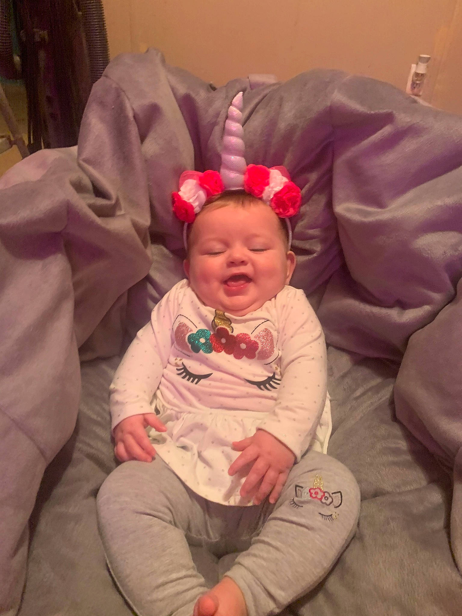 Rayna is registered to the contest to win money with this photo: baby, cheek, child, ear, fun, furniture, hair_accessory, head, lip, person, pink, sitting, skin, smile, toddler