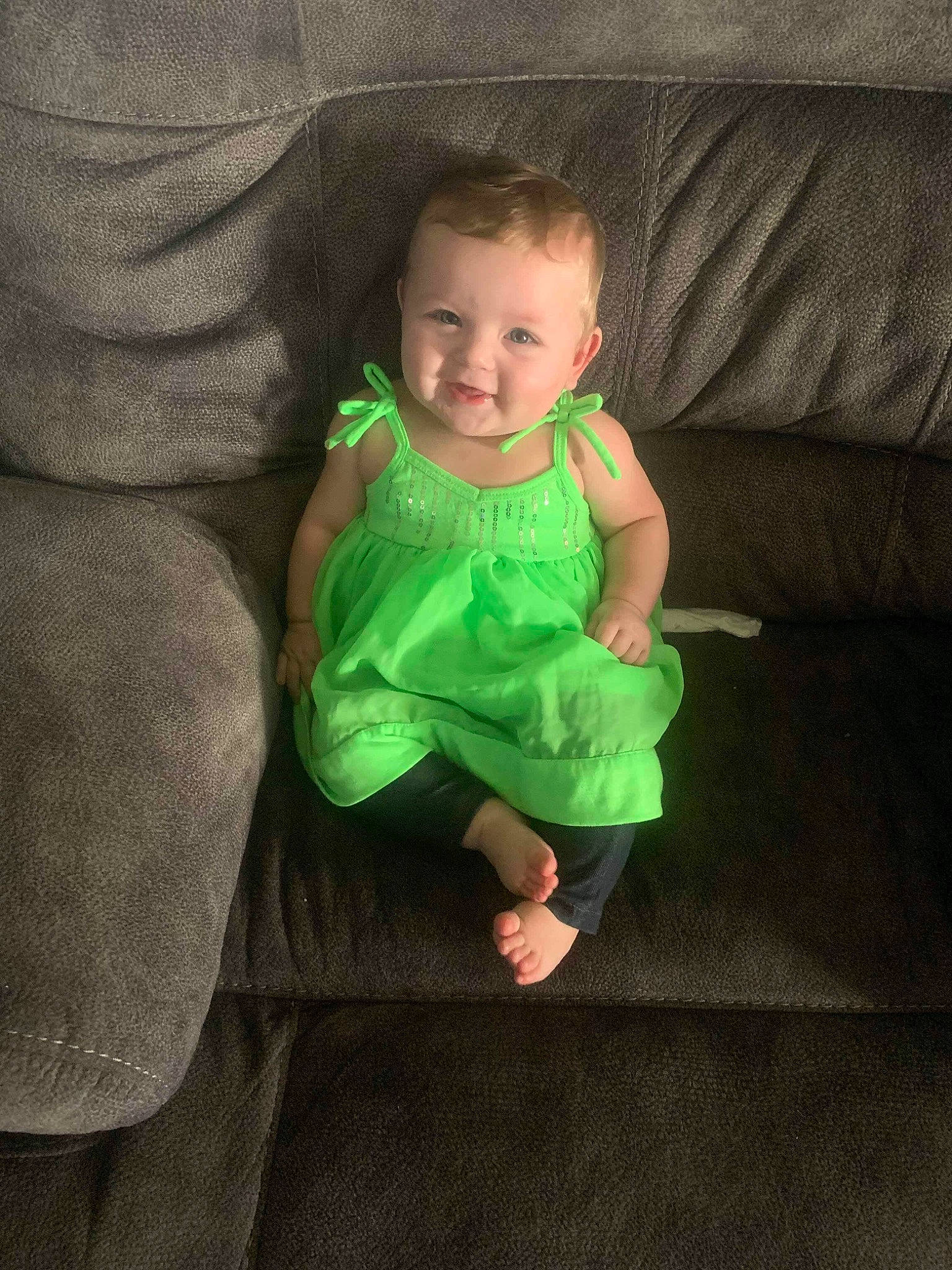 Rayna is registered to the contest to win money with this photo: baby, child, face, fun, green, head, joy, person, sitting, skin, smile, standing, toddler