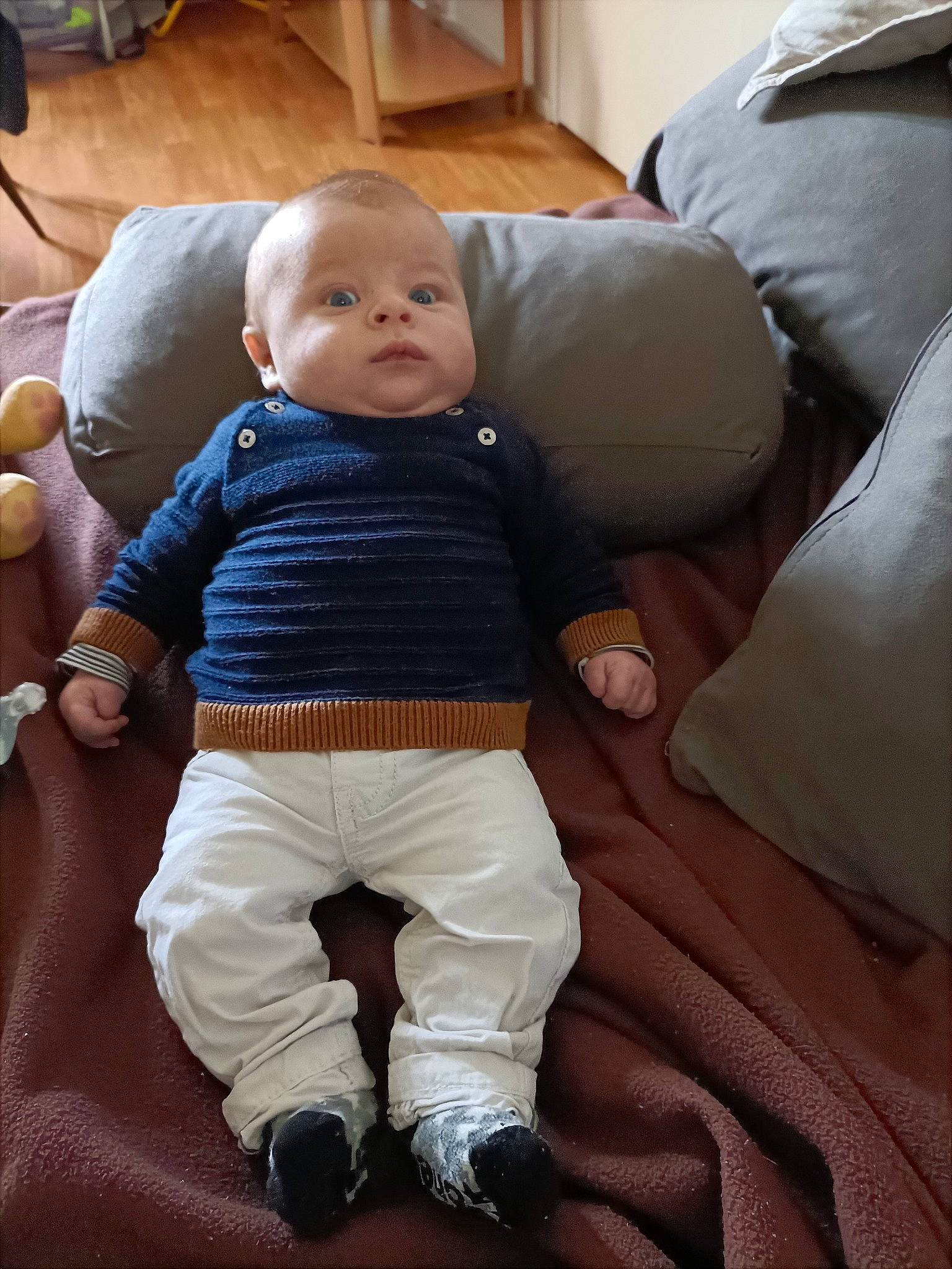 Cameron a rejoint le concours — aidez-le/la à gagner de superbes lots ! baby, baby_products, baby_toddler_clothing, cheek, child, comfort, couch, finger, flooring, fun, head, lap, person, play, product, sitting, skin, sleeve, sock, toddler