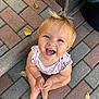baby, barefoot, blond, bricks, casual_clothing, child, cute, daylight, expression, hair, happy, infant, leaves, looking_up, outdoor, pavement, playful, portrait, sitting, smile