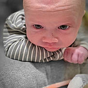 Archie joined the competition — help win amazing prizes! baby, infant, close_up, face, striped_clothing, plush_toy, duck_toy, soft_surface, resting, cute, child, young, portrait, indoors, expression, wide_eyes, skin, head, hand, newborn