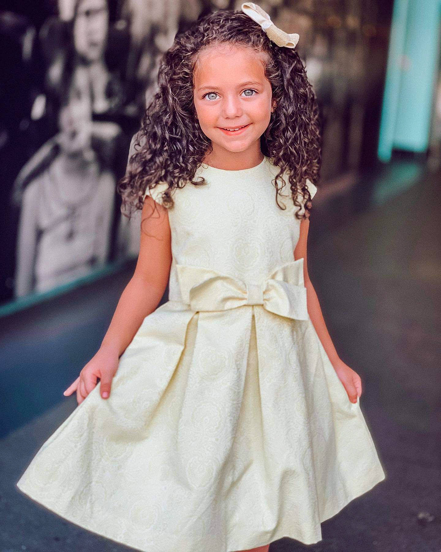 Sophie participe au concours pour gagner de l'argent avec cette photo : a_line, bridal_party_dress, brown_hair, child, child_model, clothing, day_dress, dress, fashion, fashion_design, fashion_model, flower_girl, formal_wear, gown, hairstyle, joy, lady, long_hair, person, smile