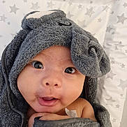 Ezra joined the competition — help win amazing prizes! baby, infant, towel, hooded_towel, gray, face, eyes, mouth, blanket, stars, pattern, cute, child, young, expression, skin, wrapped, indoors, soft, closeup