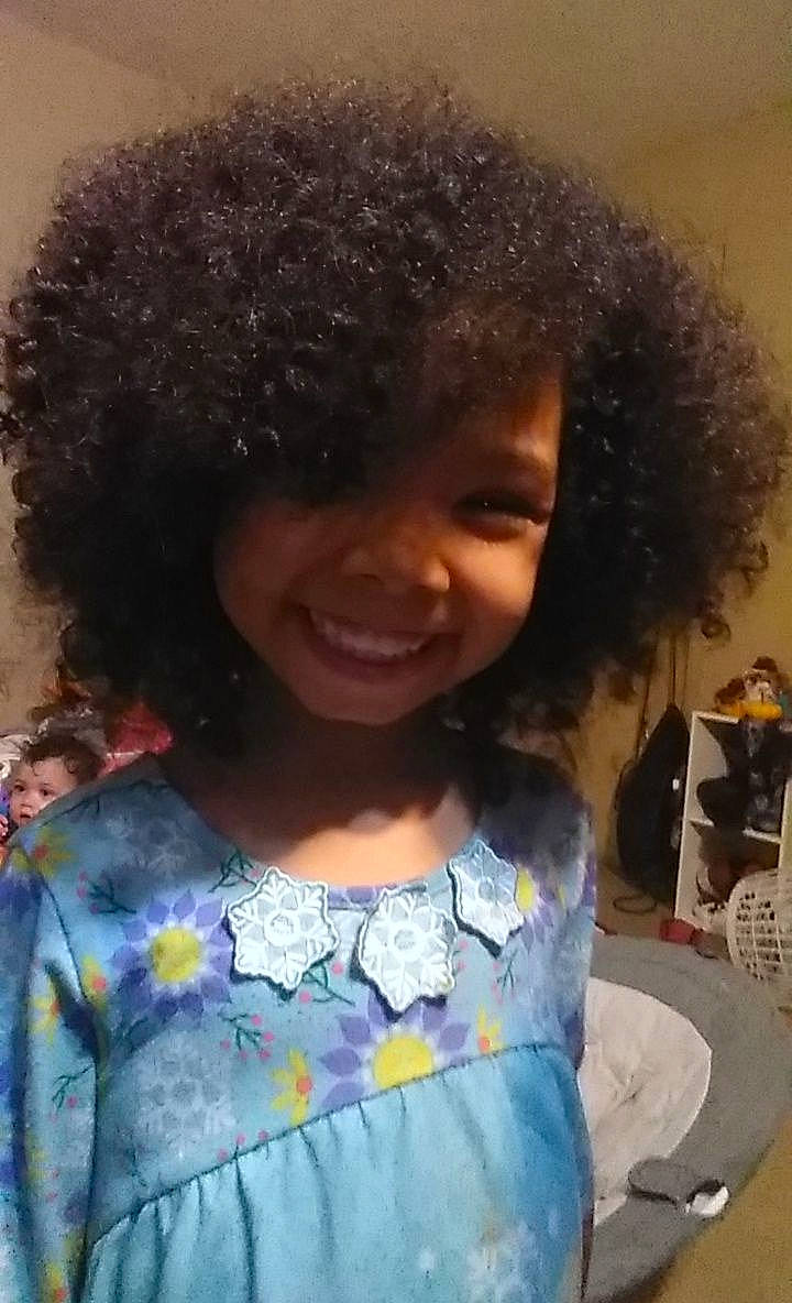 Kyra is registered to the contest to win money with this photo: afro, beauty, black_hair, chair, child, chin, cool, fashion, fun, hairstyle, happy, jheri_curl, joy, lip, nose, organ, person, ringlet, skin, smile