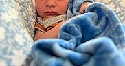 Hunter joined the competition — help win amazing prizes! baby, blanket, blue_blanket, child, clothing, cozy, cute, expression, eyes, face, hands, head, indoor, infant, newborn, patterned_blanket, portrait, skin, soft_texture, wrapped