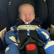 Hunter is registered to the contest to win money with this photo: baby, infant, car_seat, child, smiling, blue_onesie, cloud_pattern, safety_harness, cute, sleepy, happy, closed_eyes, headrest, straps, seatbelt, indoors, portrait, newborn, cozy, child_safety