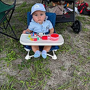Liam Gabriel is registered to the contest to win money with this photo: baby, blue_clothing, cap, casual, chair, child, dirt, expression, feet, grass, outdoor, person, plastic_toy, playtime, seat, socks, stroller, summer, sunlight, toy