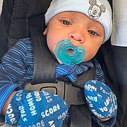 Atorion Jones is registered to the contest to win money with this photo: baby, infant, pacifier, blue_hat, mittens, car_seat, blanket, striped_clothing, child, cute, face, headwear, safety_harness, comfort, indoor, portrait, young_child, apparel, baby_clothes, resting