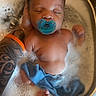 adult_hand, baby, bath, blue_cloth, blue_pacifier, bubble_bath, bubbles, closeup, foot, hand, infant, pacifier, peaceful, sink, skin, sleeping, soapy_water, tattoo, tattooed_arm, water