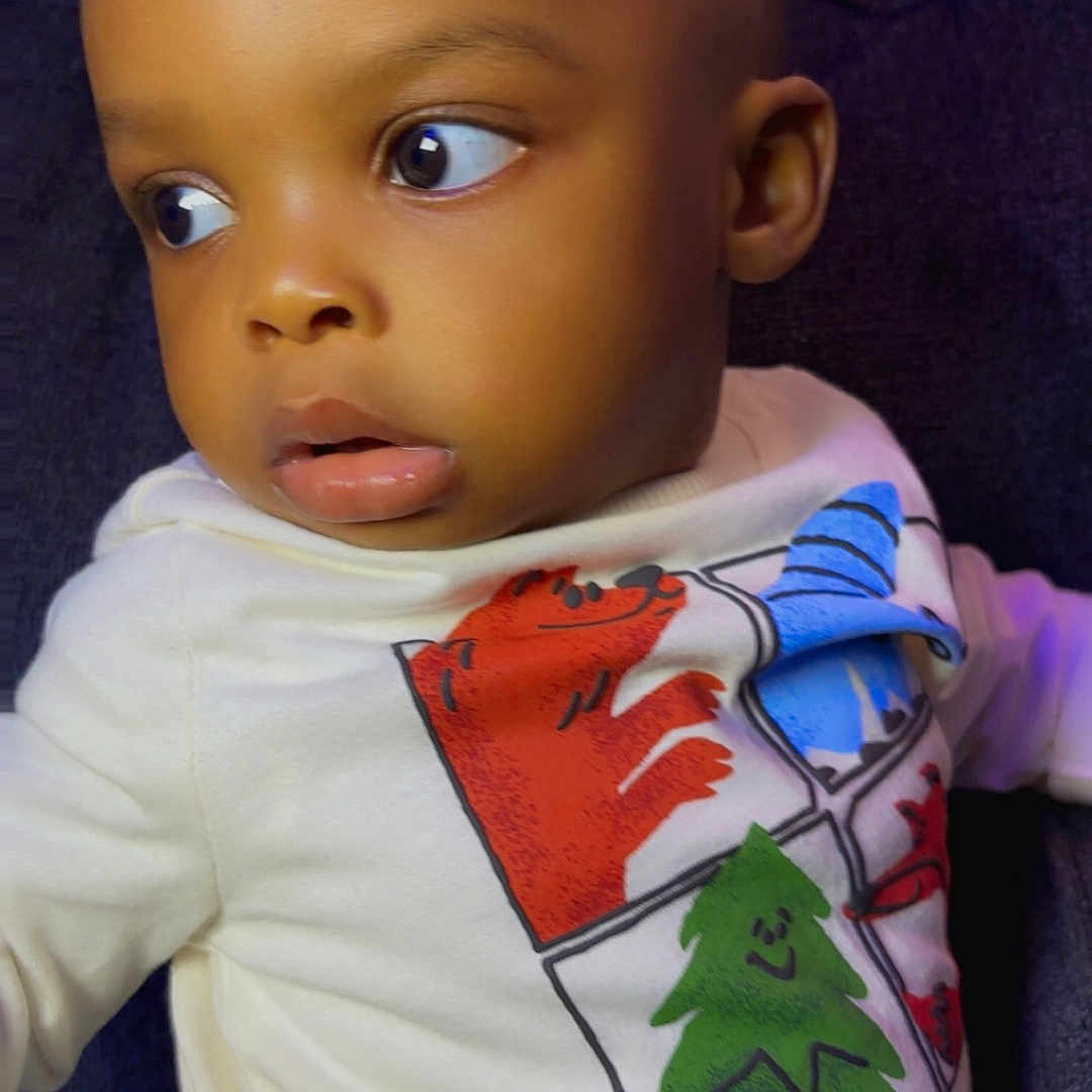 Kamsiriochukwu is registered to the contest to win money with this photo: animal, baby, background, cartoon, child, clothing, curious, cute, expression, eyes, face, head, indoors, person, portrait, shirt, sitting, toddler, tree, young_child
