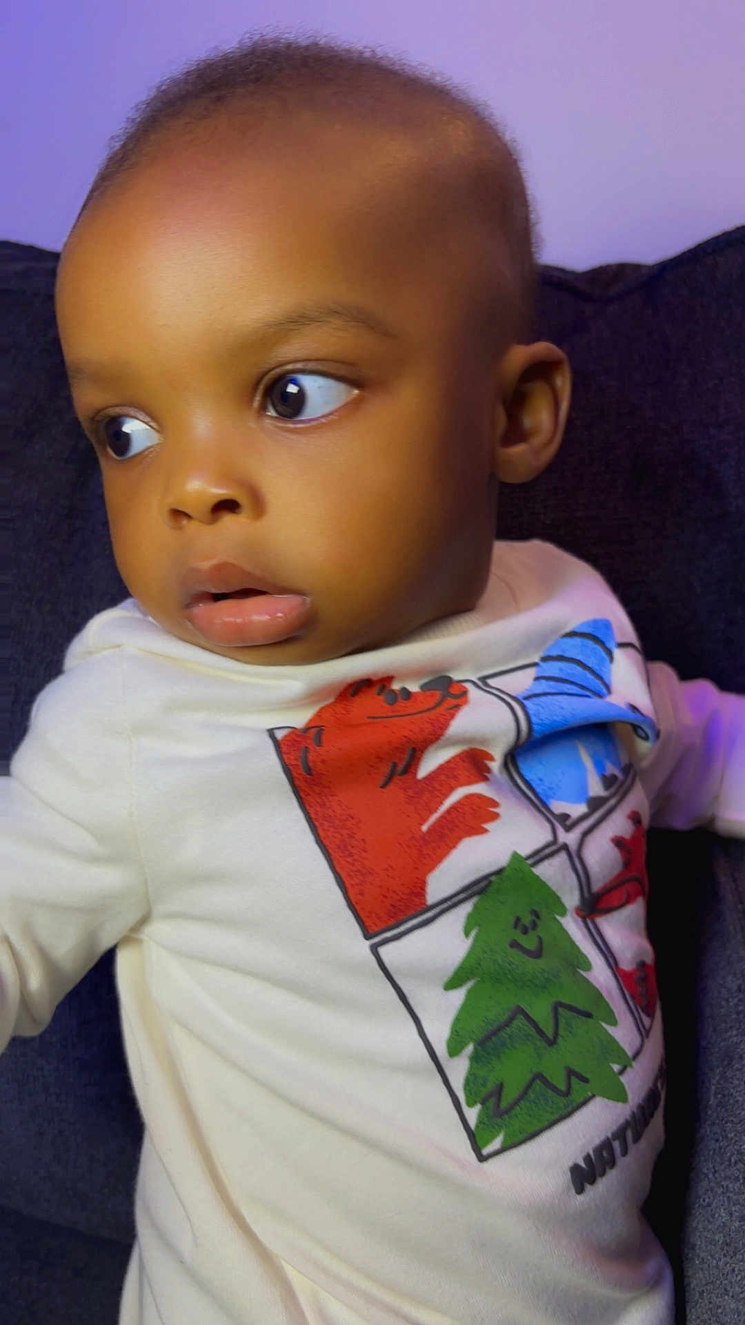 Kamsiriochukwu is registered to the contest to win money with this photo: toddler, child, face, eyes, shirt, cartoon, animal, tree, clothing, sitting, indoors, portrait, expression, curious, young_child, baby, cute, person, head, background