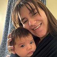 Elena joined the competition — help win amazing prizes! woman, baby, smile, face, portrait, indoor, curtain, baby_carrier, holding, person, head, hair, clothing, skin, closeup, parent, child, happy, family, love