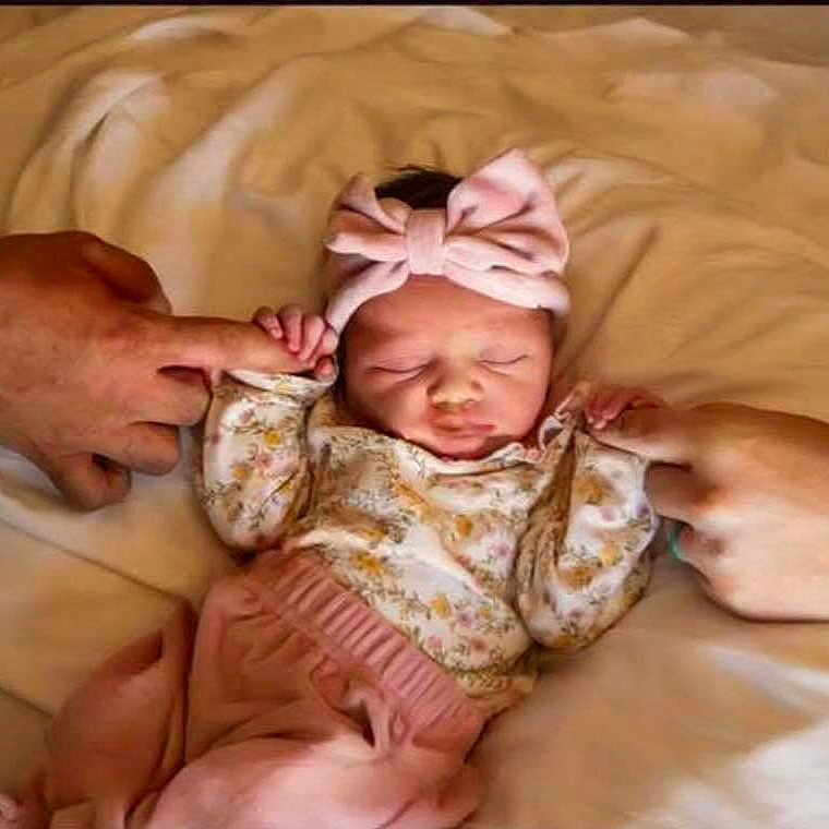 Izzybella joined the competition — help win amazing prizes! adult_hand, baby, bed, blanket, bow, cozy, cute, family, floral_pattern, headband, holding_fingers, infant, love, newborn, pink_clothing, portrait, resting, sleeping, soft_lighting, toddler