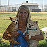Margarita Olive is registered to the contest to win money with this photo: animal, blue_harness, casual_clothing, chihuahua, daytime, dog, fence, grass, holding, house, leash, nature, outdoor, park, person, pet, portrait, small_dog, sunlight, woman