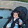 baby, child, stroller, outdoor, park, pond, water, bench, pigtails, smiling, face, portrait, sitting, harness, baby_clothing, shoes, playground, nature, daylight, family_outing