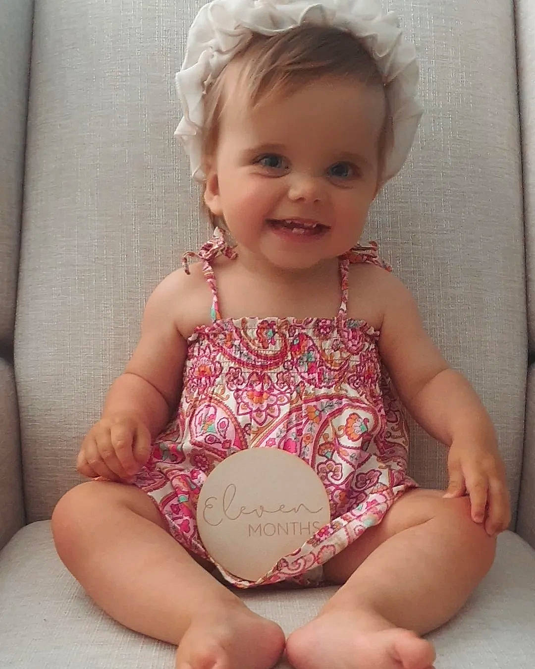Sienna Mae is registered to the contest to win money with this photo: arm, baby, baby_toddler_clothing, cheek, clothing, comfort, dress, eye, hair, happy, human_body, iris, joy, knee, leg, person, pink, skin, sleeve, smile