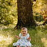 Love is registered to the contest to win money with this photo: baby, child, grass, tree, outdoor, dress, smile, barefoot, sunlight, nature, greenery, happy, sitting, portrait, infant, young_child, summer, daylight, cute, background_blur
