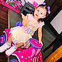 Avianna joined the competition — help win amazing prizes! accessories, baby, chair, clothing, costume, couch, dress, face, footwear, furniture, head, indoors, person, photography, portrait, purple, shoe, sitting, t_shirt, toy