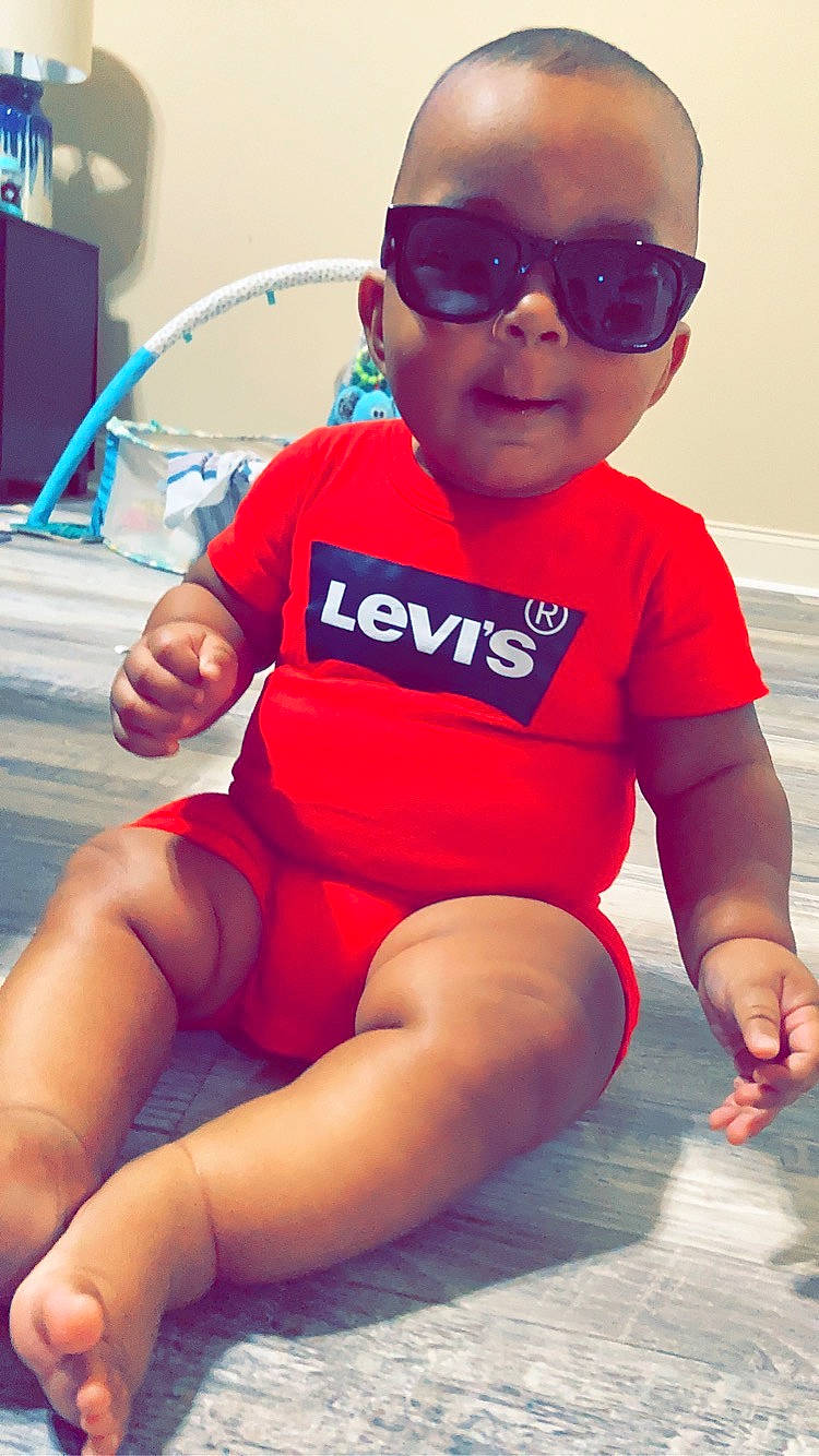 Kanan is registered to the contest to win money with this photo: baby, baby_toddler_clothing, child, cool, dress, eyewear, face, finger, glasses, goggles, happy, knee, lip, neck, person, red, sleeve, sunglasses, thigh, toddler
