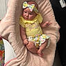 Miller Grace is registered to the contest to win money with this photo: baby, blanket, bow, carpet, child, cozy, cute, expression, floor, floral, headband, home, indoor, infant, person, pink, portrait, sitting, soft_texture, yellow_clothing