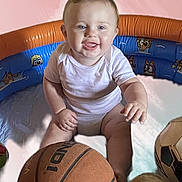 Carl joined the competition — help win amazing prizes! baby, infant, smiling, sitting, inflatable_pool, basketball, soccer_ball, toy, child, playtime, indoor, white_clothing, cute, happy, young_child, face, head, skin, fun, expression