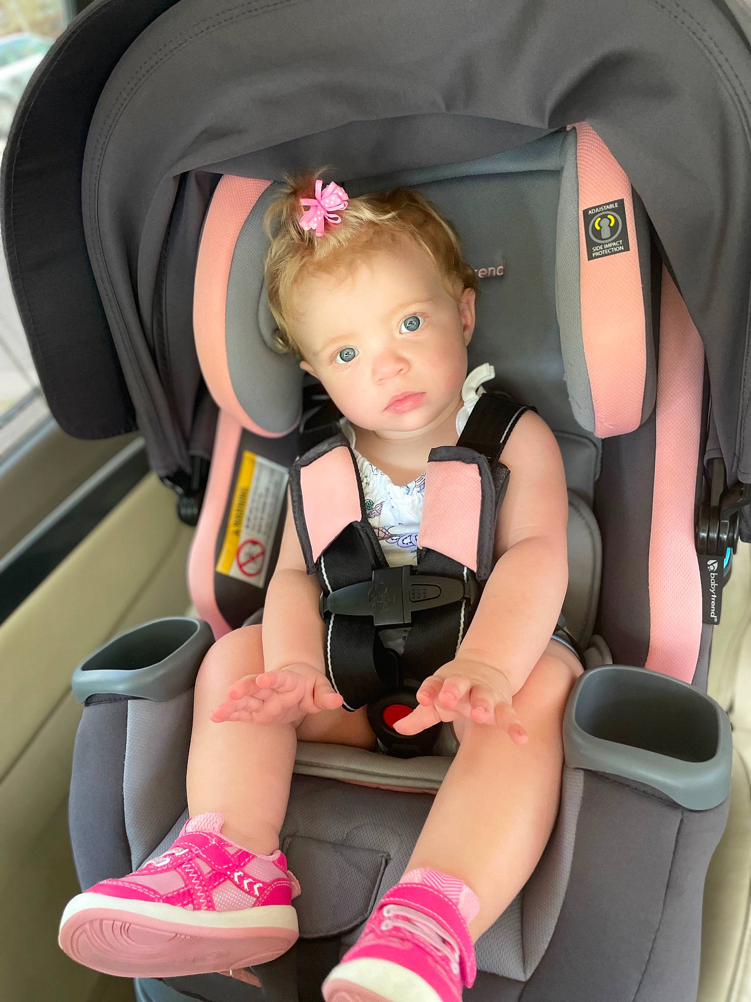 Maddison is registered to the contest to win money with this photo: auto_part, automotive_design, baby, baby_products, car_seat, car_seat_cover, child, comfort, head_restraint, human_leg, knee, lap, leg, person, pink, seat_belt, sitting, steering_wheel, thigh, toddler