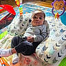 Klins joined the competition — help win amazing prizes! baby, infant, child, portrait, lying_down, sitting, face, eyes, looking_at_camera, calm, clothing, gray_shirt, black_pants, sock, play_mat, baby_cushion, toys, rattle, stuffed_monkey, indoor