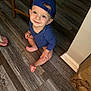 Connor is registered to the contest to win money with this photo: baby, babycrawling, baseballcap, bodypart, cap, clothing, crawling, face, hardwood, hat, head, indoors, interiordesign, pants, person, photography, portrait, sitting, stainedwood, wood