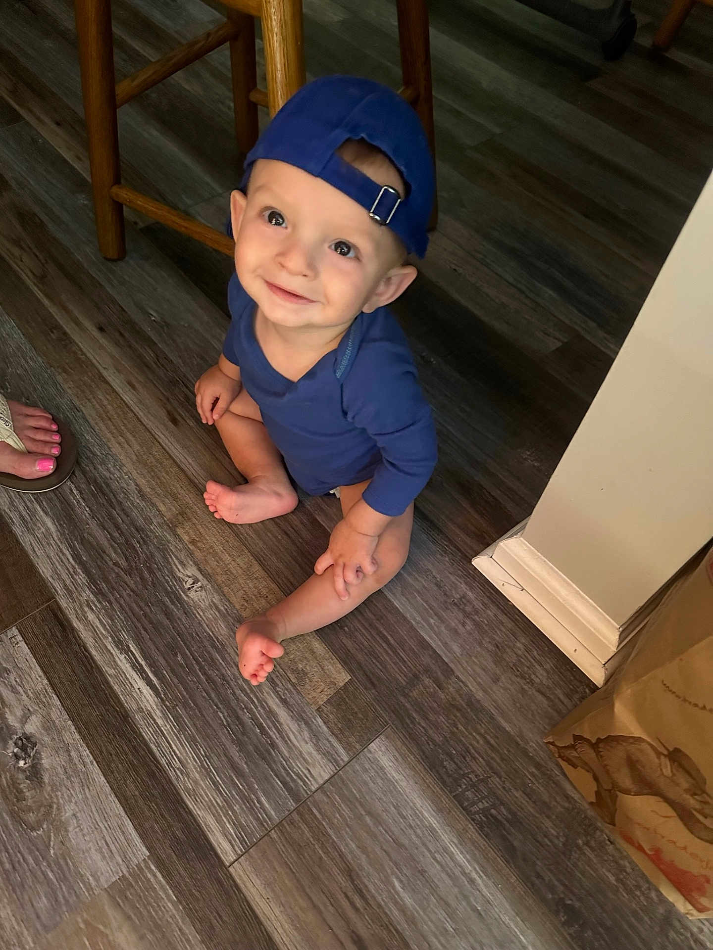 Connor is registered to the contest to win money with this photo: baby, babycrawling, baseballcap, bodypart, cap, clothing, crawling, face, hardwood, hat, head, indoors, interiordesign, pants, person, photography, portrait, sitting, stainedwood, wood