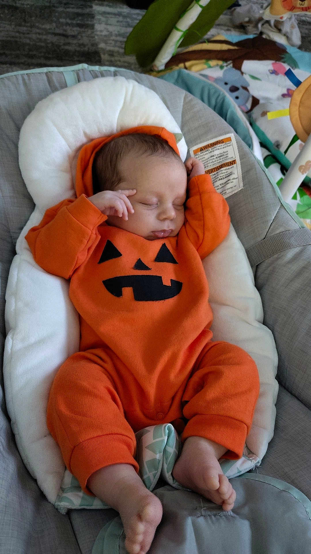 Jace joined the competition — help win amazing prizes! baby, sleeping, pumpkin_onesie, orange_clothing, infant, cushion, baby_seat, blanket, cozy, foot, hand, cute, indoors, child, newborn, soft_toys, head_support, peaceful, resting, baby_clothes