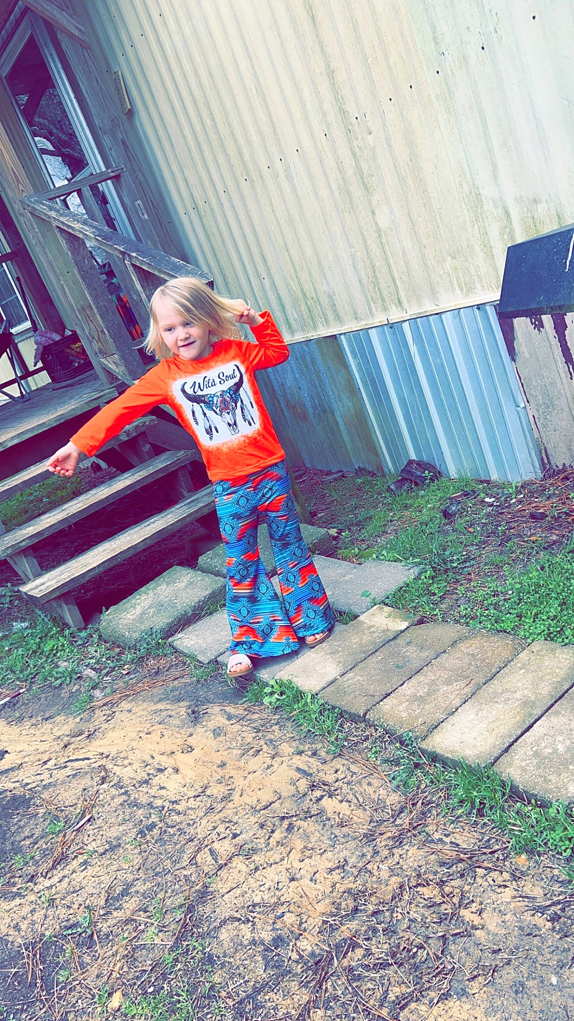 Melanie is registered to the contest to win money with this photo: denim, electric_blue, fun, grass, happy, human_leg, joy, leisure, magenta, pattern, person, plant, recreation, sitting, smile, soil, sportswear, t_shirt, tints_and_shades, toddler