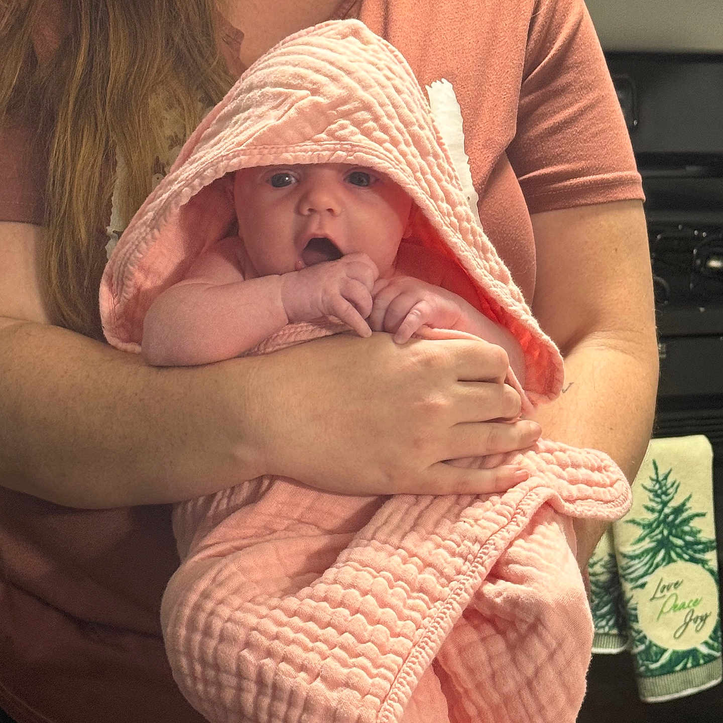 Journey joined the competition — help win amazing prizes! adult, arms, baby, child, clothing, comfort, curious, expression, holding, hood, human, indoor, kitchen, person, pink, portrait, textile, towel, warmth, wrapped