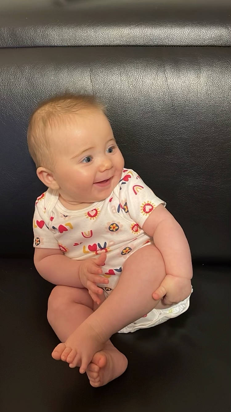 Angelina is registered to the contest to win money with this photo: arm, baby, baby_toddler_clothing, cheek, child, chin, comfort, eye, facial_expression, finger, flash_photography, flooring, hairstyle, happy, iris, lip, person, skin, sleeve, smile