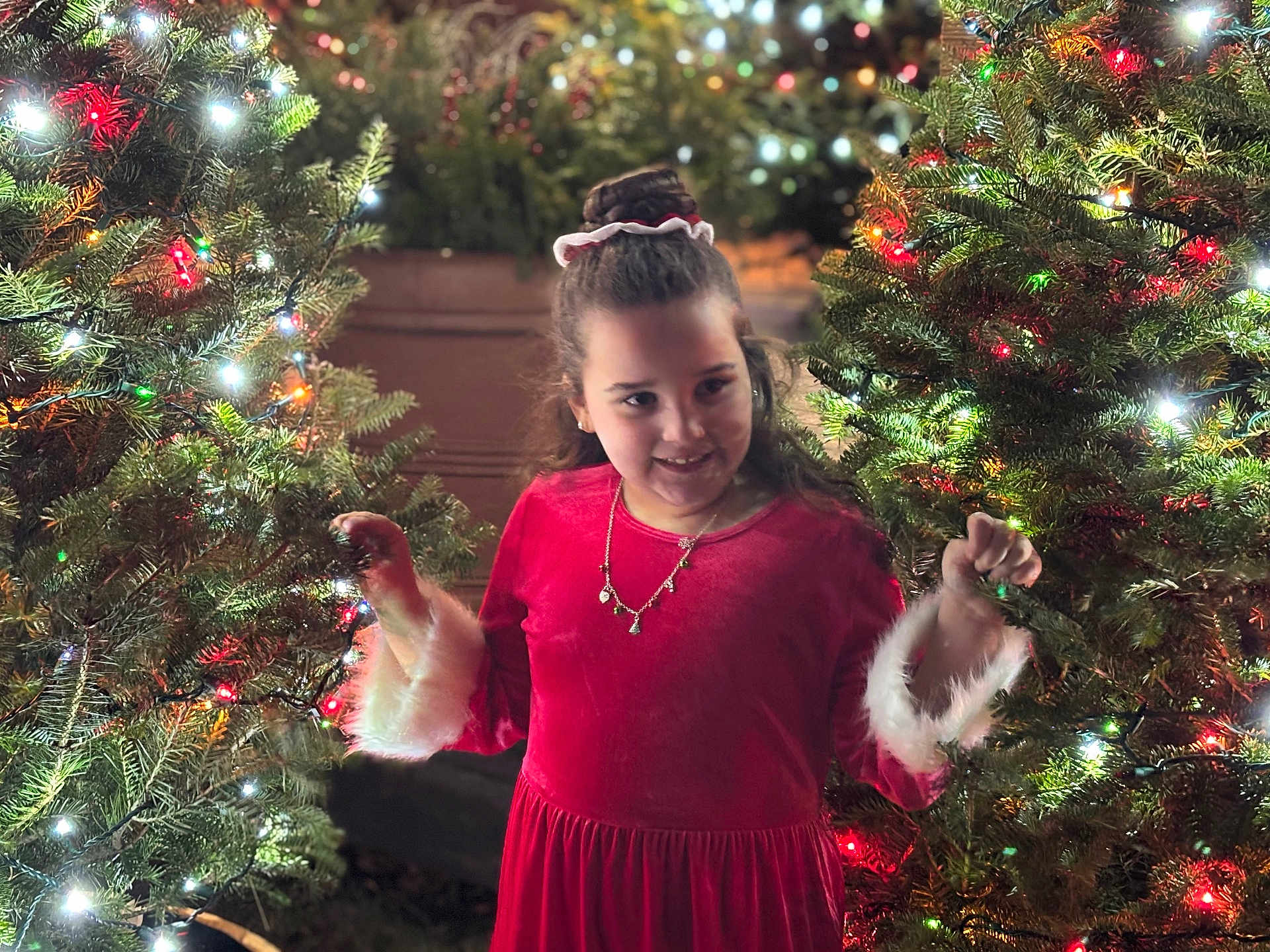 Takeila joined the competition — help win amazing prizes! child, girl, red_dress, christmas_tree, holiday_lights, festive, smiling, outdoor, night, decorations, celebration, happy, long_hair, necklace, holiday_season, evergreen, tree_lights, winter, joy, dress